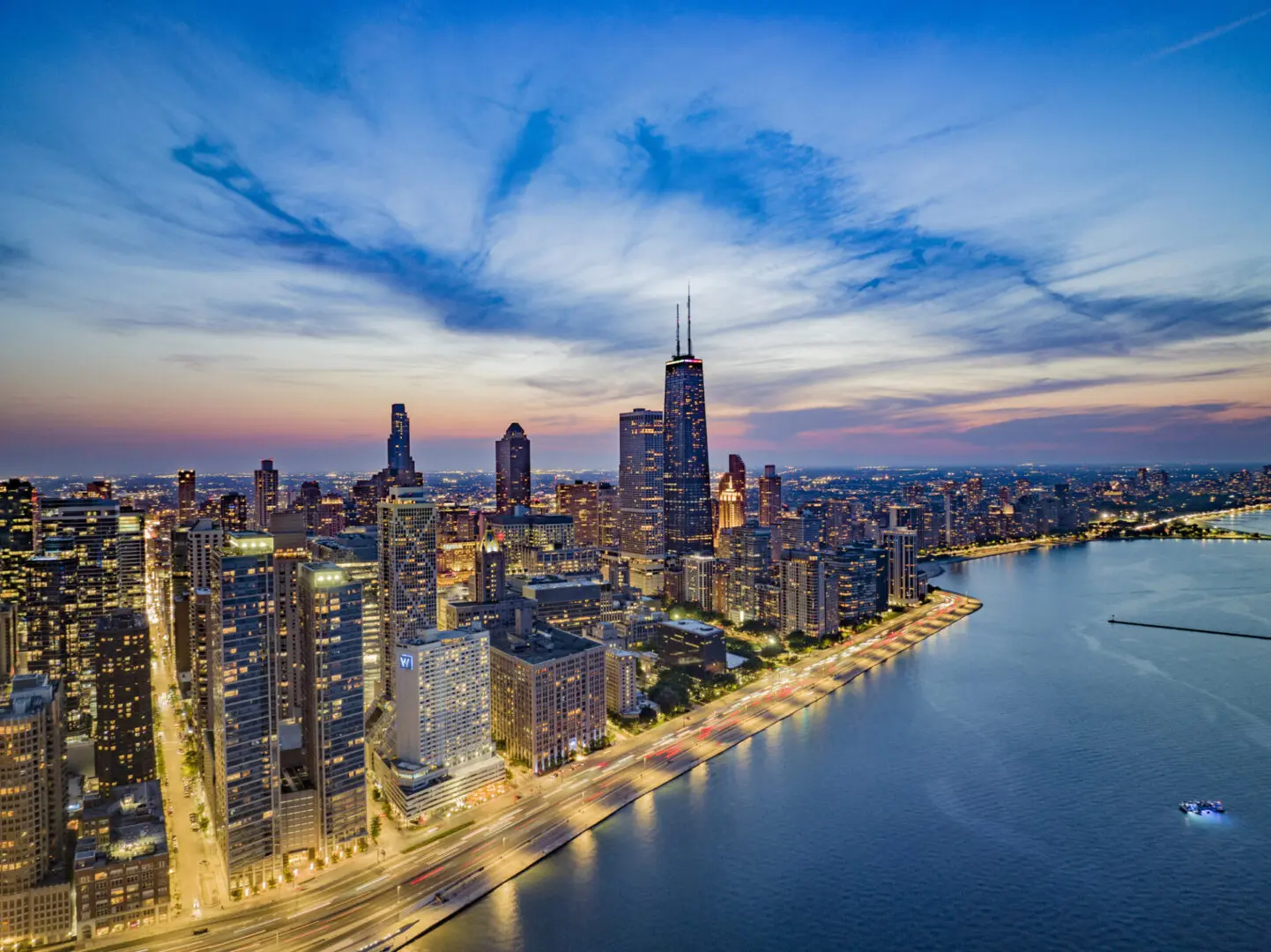 Chicago skyline at dusk with waterfront.